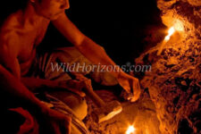 Miner within a mountainside tunnel chips away rock in search of amber. The only tools used in these mines are a short-handled shovels, small sledge hammers, chisels, and candles. Dominican Republic, Hispaniola, West Indies. No model release, but photographed with permission.