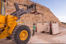 Moving a large slab of fossiliferous limestone at a quarry near Kemmerer, Wyoming, owned by Green River Stone Company, headquartered in Logan, Utah. This crew is excavating the "18-inch" layer, which refers to the average thickness of the rock layer containing the most fossils from an ancient lakebed of Eocene age in the Green River Formation of SW Wyoming, USA. The quarry is in close proximity to Fossil Butte National Monument. Model Releases available for all people shown in this series of photos. The quarry manager is Matt Helm (brown shirt), and his crew are David Dilworth (green t-shirt), Dallin Ahrnsbrak (white t-shirt), and Jacob Benner (red t-shirt).