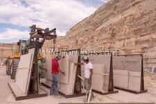 Moving a large slab of fossiliferous limestone to an A-frame pallet at a quarry near Kemmerer, Wyoming, owned by Green River Stone Company, headquartered in Logan, Utah. This crew is excavating the "18-inch" layer, which refers to the average thickness of the rock layer containing the most fossils from an ancient lakebed of Eocene age in the Green River Formation of SW Wyoming, USA. The quarry is in close proximity to Fossil Butte National Monument. Model Releases available for all people shown in this series of photos. The quarry manager is Matt Helm (brown shirt), and his crew are David Dilworth (green t-shirt), Dallin Ahrnsbrak (white t-shirt), and Jacob Benner (red t-shirt).
